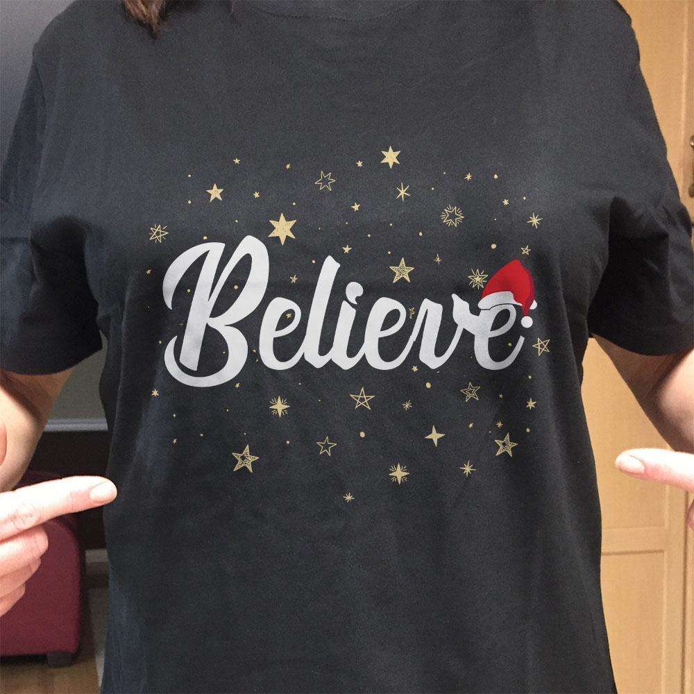 Designs by MyUtopia Shout Out:Believe Stars and Santa Hat Adult Unisex T-Shirt