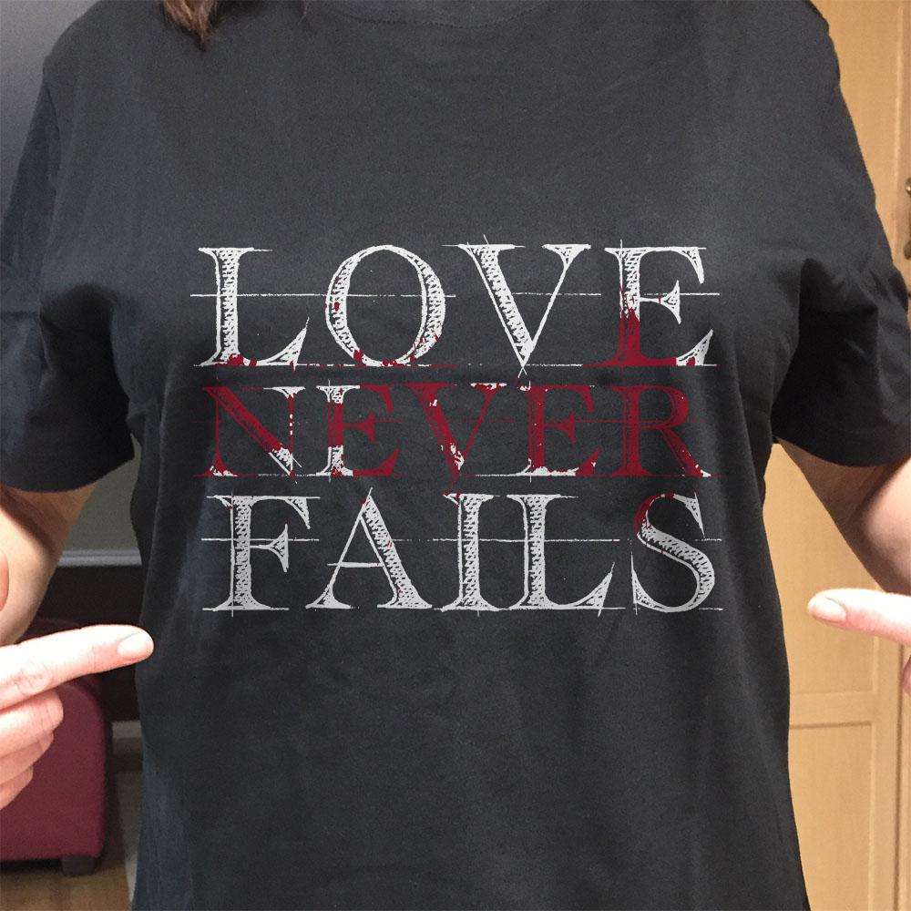 Designs by MyUtopia Shout Out:Love Never Fails Adult Unisex T-Shirt